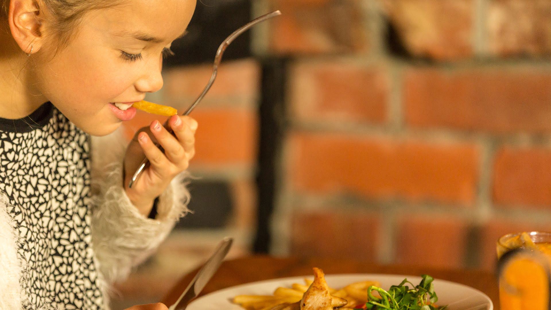 Child enjoying dinner at the Powderkeg Bar and Restaurant in Ohakune - Visit Ruapehu.jpg