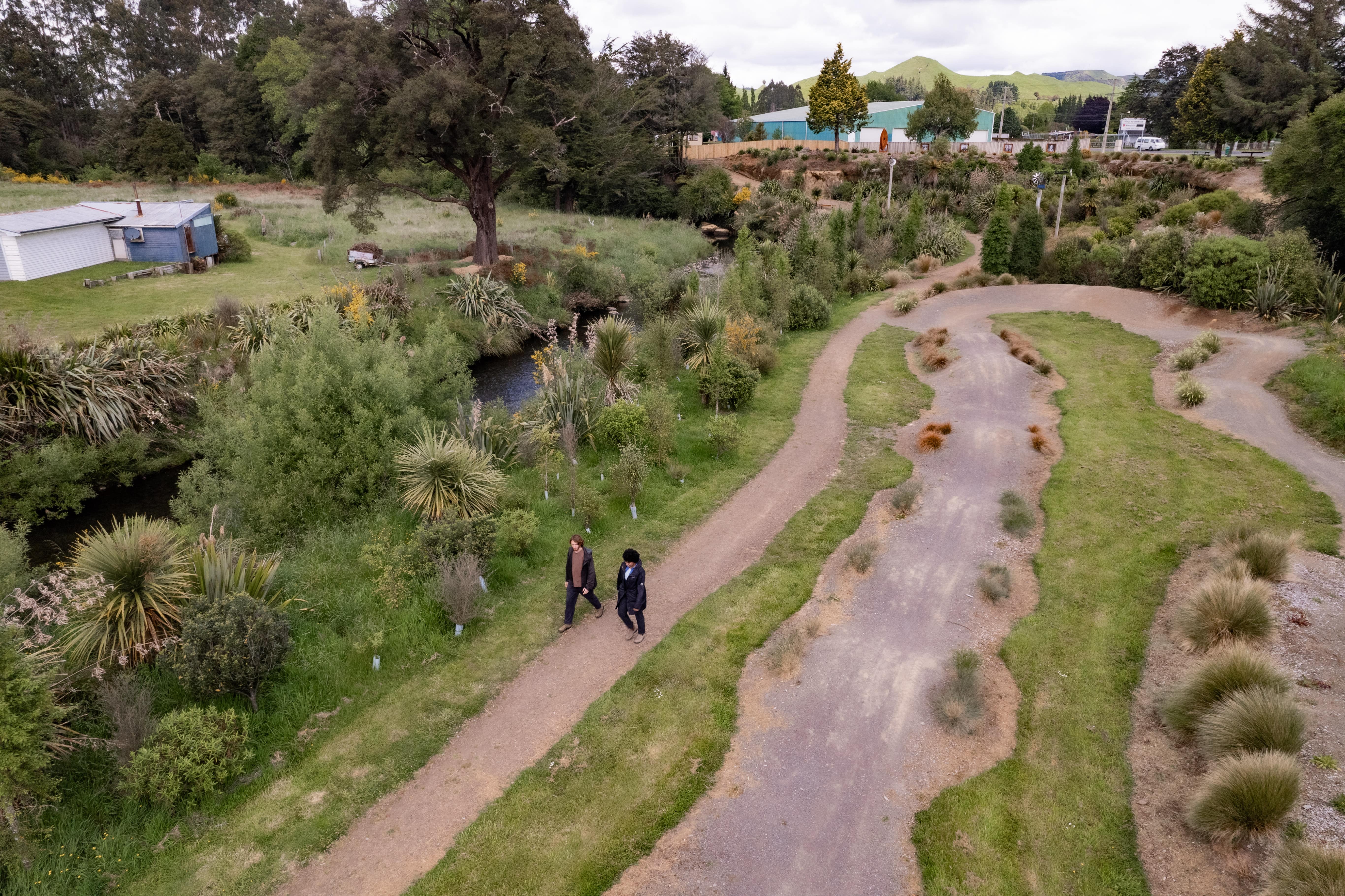 Couple walking along the Mākōtūku River Track.jpg