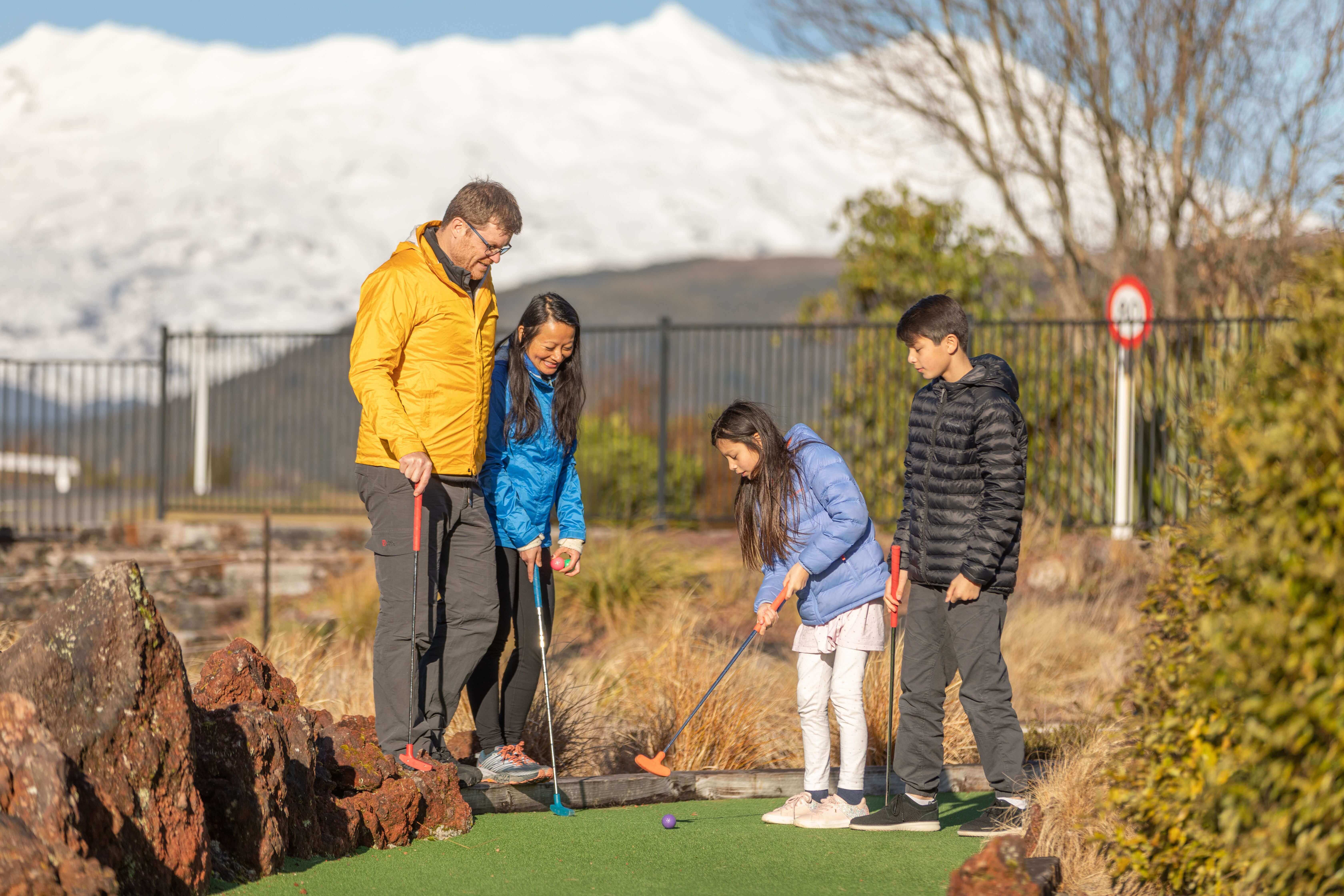 Family playing minigolf at Schnapps in National Park Village - Visit Ruapehu-min.jpg